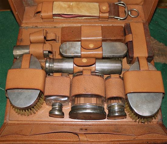 Travelling toilet case with silver topped bottles